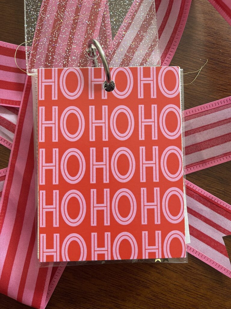 Album title page with a repeated "HO HO HO" pattern in pink and white.
