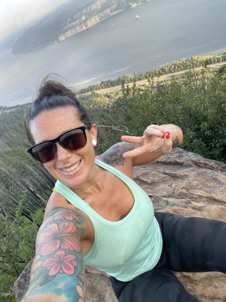 A selfie of me on a boulder, with the early morning Columbia River in the background. 