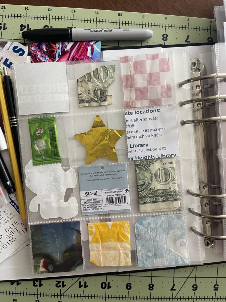 The back of the 6-inch by 8-inch page protector divided into 12 two-inch by two-inch pockets holding ephemera from my life in July 2025. 