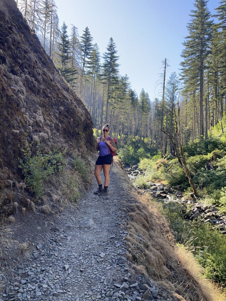 Me, standing on the trail and smiling at the camera.