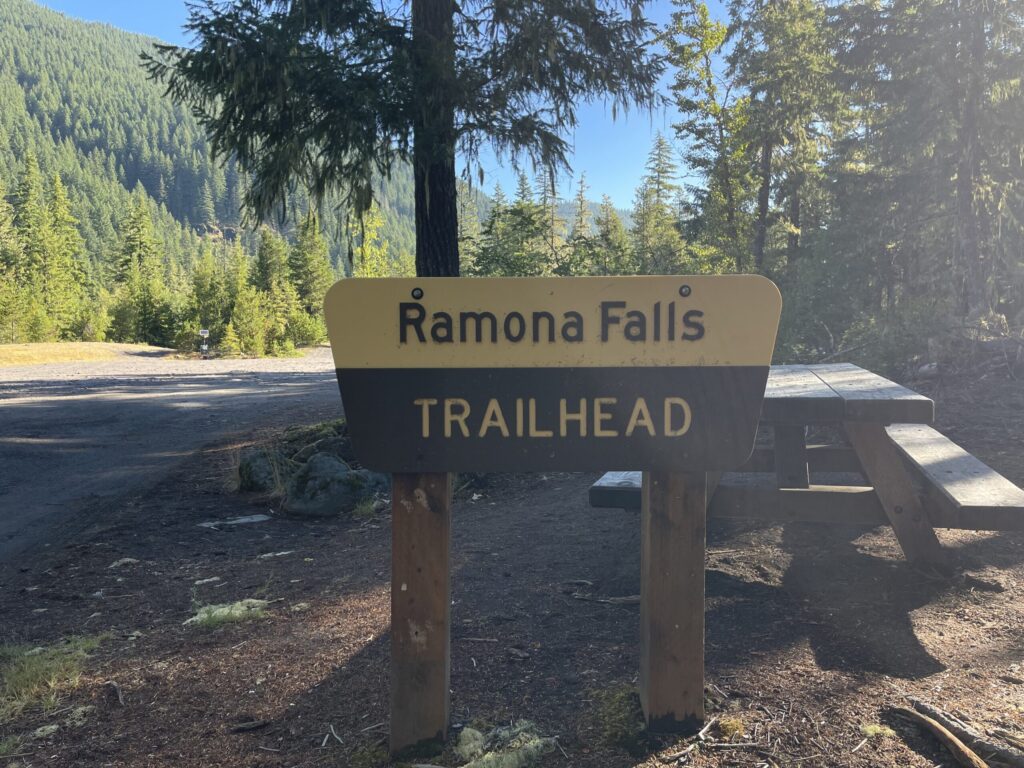 A National Forest sign that reads, "Ramona Falls Trailhead" at the entrance to the enormous Ramona Falls trailhead parking lot. 