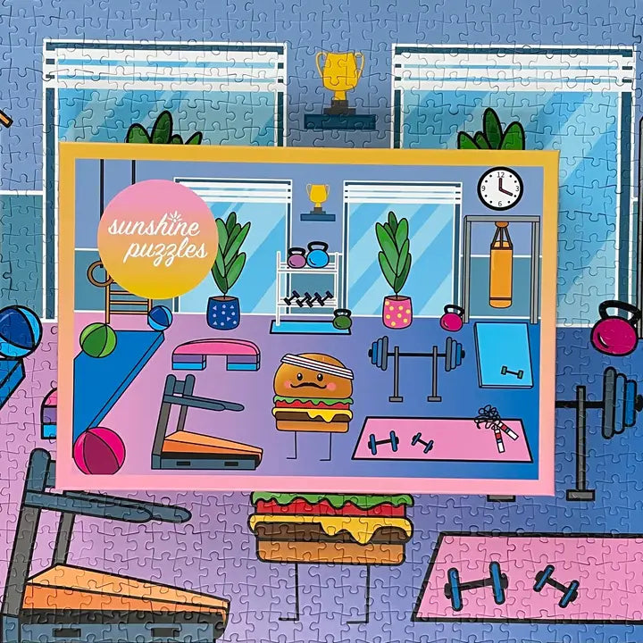 A 1,000-piece puzzle of a cartoon hamburger working out in a gym surrounded by gym equipment including a barbell and squat rack, treadmill, aerobic steps, and yoga mat. 