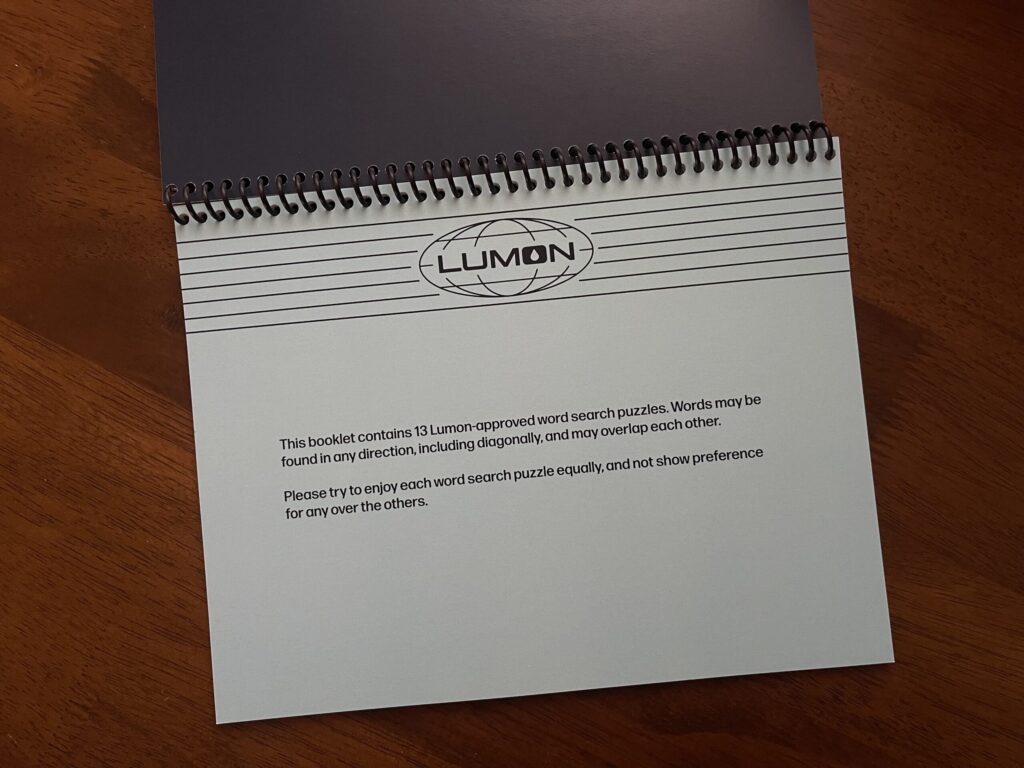 The title page to the booklet. The Lumon logo/letterhead and page text are in black against a light blue page. The page reads, "This booklet contains 13 Lumon-approved word search puzzles. Words may be found in any direction, including diagonally, and may overlap each other. Please try to enjoy each word search puzzle equally, and not show preference for any over the others."