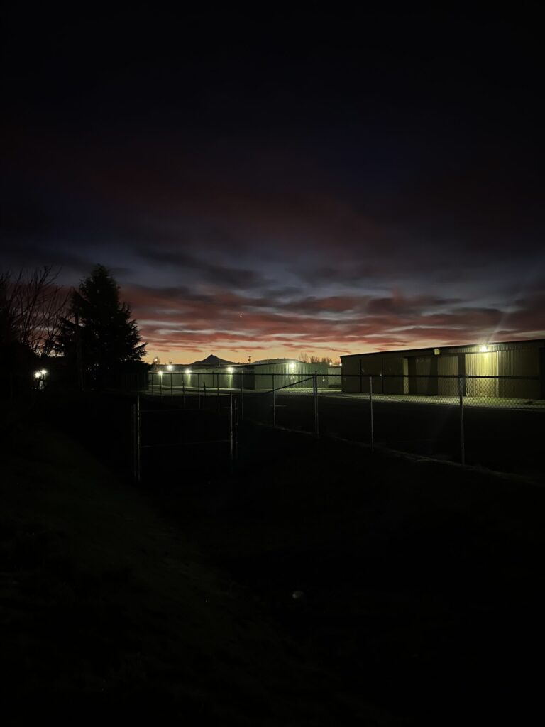Just before sunrise with reddish, blueish clouds in the sky. 