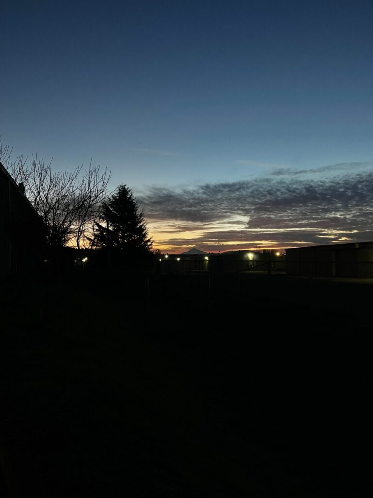 Partially cloudy sunrise over Mount Hood. 