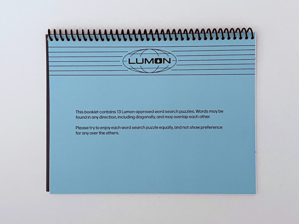 A lighter blue page featuring a Lumon header and the words, "This booklet contains 13 Lumon-approved word search puzzles. Words may be found in any direction, including diagonally, and may overlap each other. Please try to enjoy each word search puzzle equally, and not show preference for any over the others."