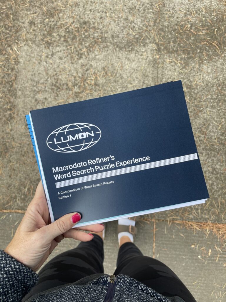 My hand holding an unbound proof of what ultimately became the final word search booklet. 