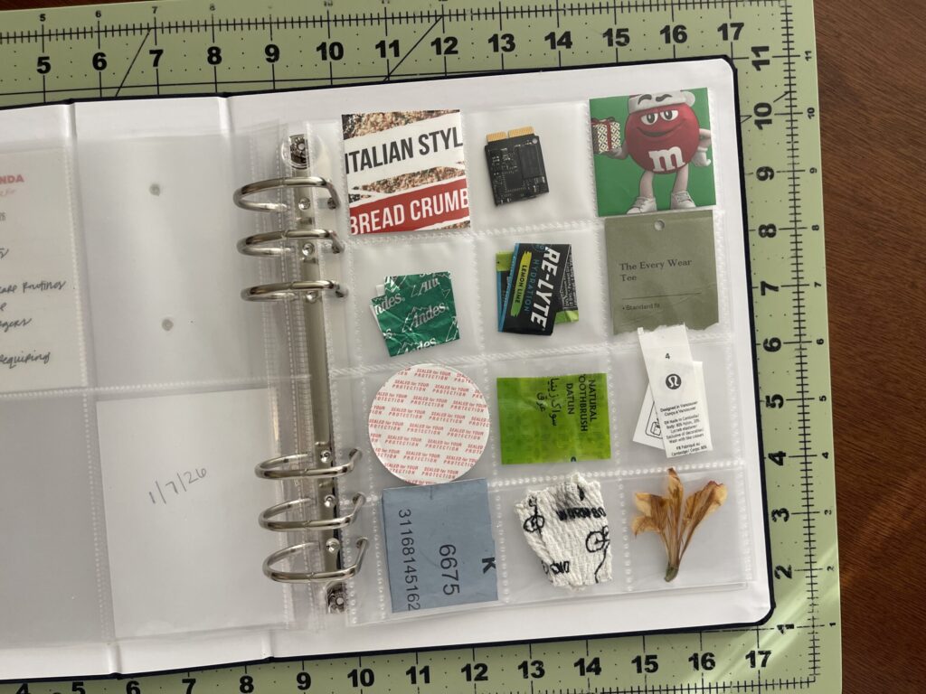 A 6-inch by 8-inch page protector divided into 12 two-inch by two-inch pockets. Each pocket hold a piece of ephemera from my life in January 2026, as enumerated in the bulleted lists in the body of the post.