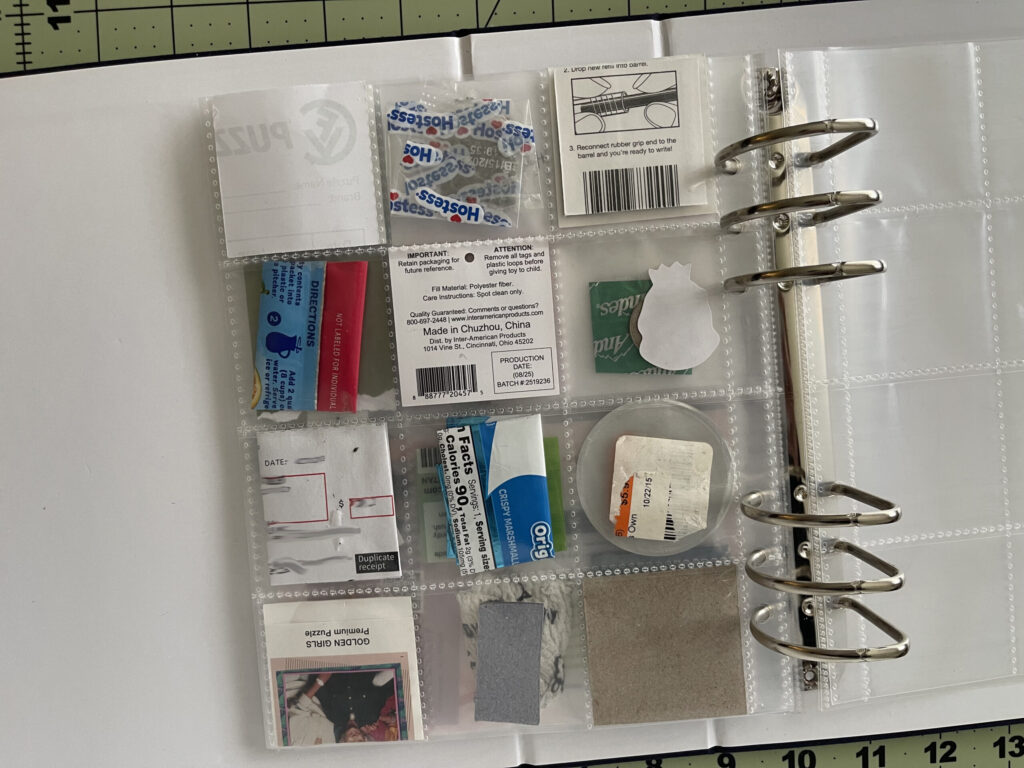 Back of a 6-inch by 8-inch page protector divided into 12 two-inch by two-inch pockets. Each pocket hold a piece of ephemera from my life in February 2026, as enumerated in the bulleted lists in the body of the post.