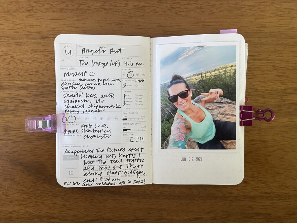 Spread of my hike of Angel's Rest, a 4.6-mile hike in the Columbia River Gorge, summer 2025. Details about the hike are written on the left page, a photo of me from the hike is on the right page, with the date of the hike stamped beneath it.