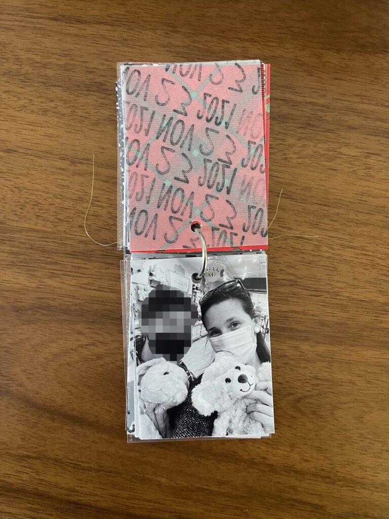 2021: the vellum page stamped with the date is flipped over to reveal a black-and-white photo of me and one of my kids posing with our stuffed animals inside Build-A-Bear. 