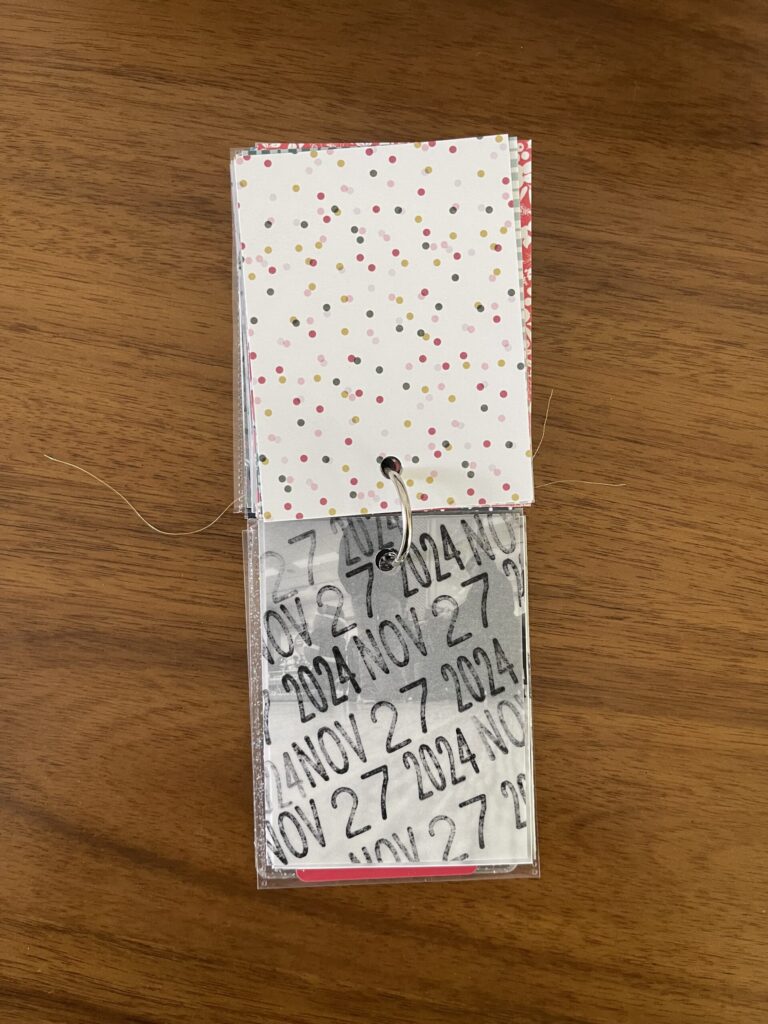 2024. The top page is a piece of patterned paper. The bottom page is a piece of vellum stamped repeatedly with the date. Beneath the vellum is a black-and-white photo from that year's visit. 