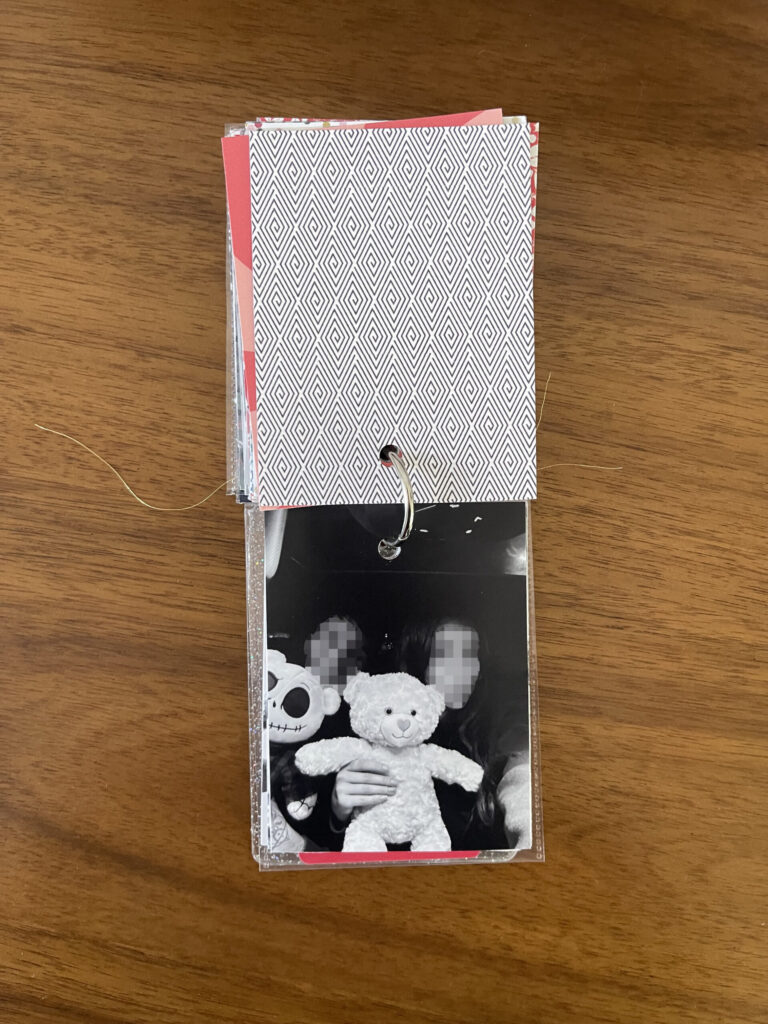 2024: a black-and-white photo of one of my kids and a friend posing with their Build-A-Bears in her car.