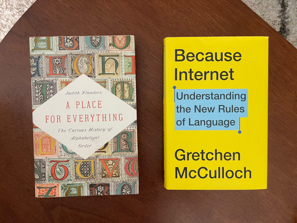 The books "A Place for Everything" and "Because Internet" face up on a wooden table.