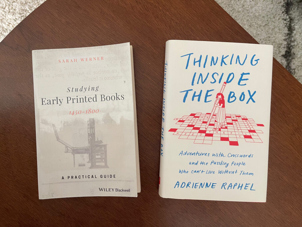 The books "Studying Early Printed Books" and "Thinking Inside the Box" face up on a wooden table.