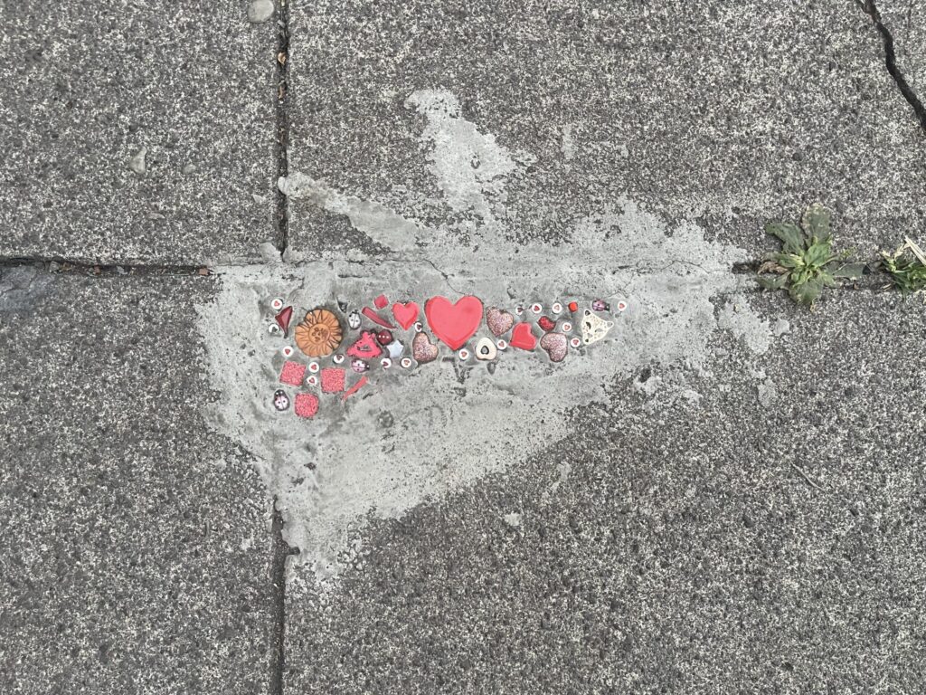 Orange and red beads, mostly of hearts and the sun. 