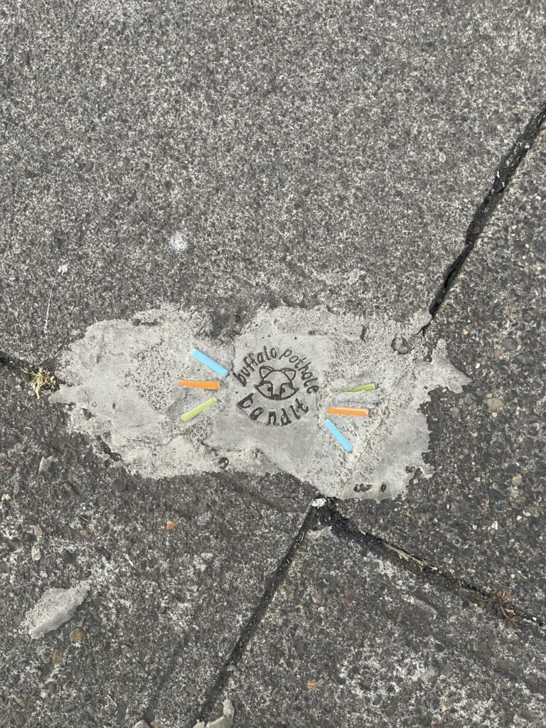 "buffalo pothole bandit" and the face of a raccoon. 