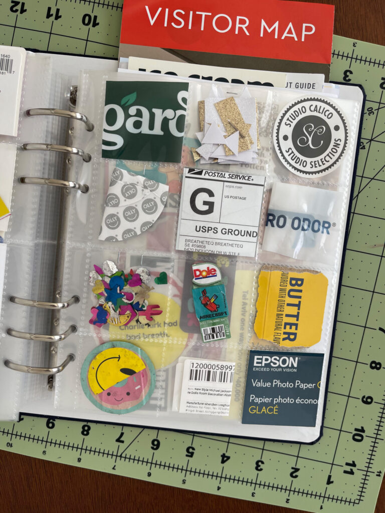 A 6-inch by 8-inch page protector divided into 12 two-inch by two-inch pockets. Each pocket hold a piece of ephemera from my life in September 2026, as enumerated in the bulleted lists in the body of the post.